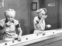 Lucy eating chocolates off the assembly line